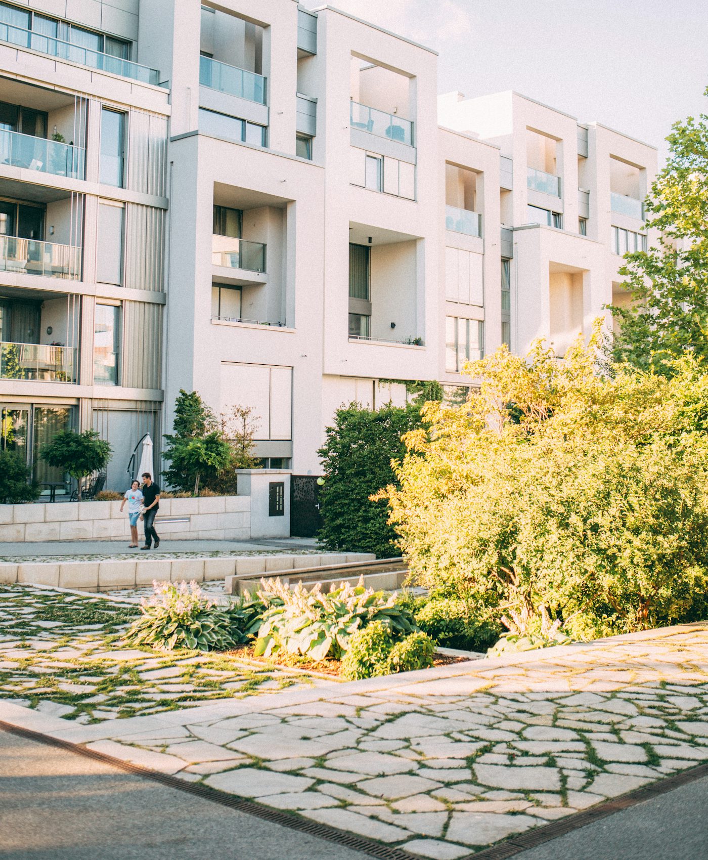 Modern white apartment building with gardens