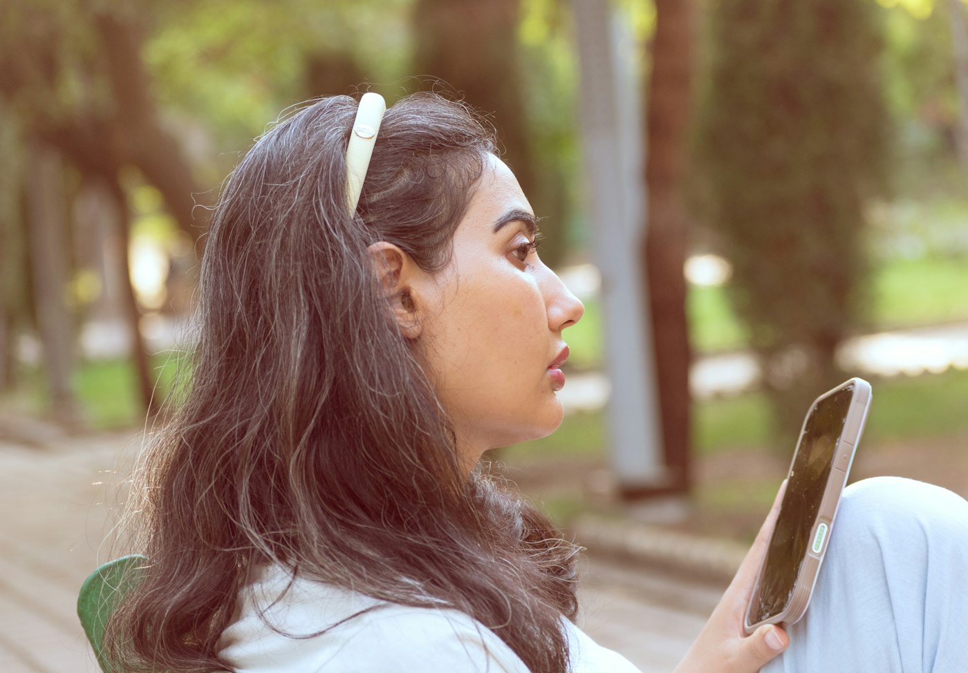 Resident using the society app on her phone outdoors
